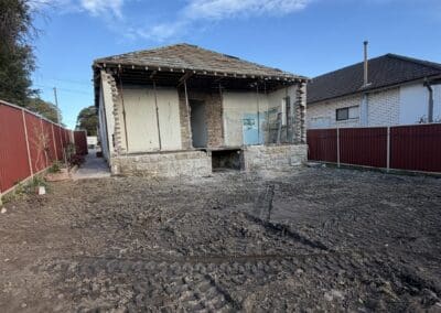 Back extension and sheds demolished at a Bexley home with the yard cleared